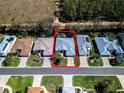 Aerial view of a single-Gathering home, enclosed pool, and neighborhood in a suburban community at 5241 Indian Ocean Loop, Tavares, FL 32778