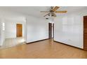 Open living room with wood laminate flooring and abundant natural light at 6213 Highland Ave, Leesburg, FL 34748