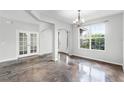 Open concept living area featuring concrete floors, arched entryways, and natural light at 9825 Sandy Pines Rd, Clermont, FL 34711