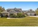 Beautifully landscaped home with a manicured lawn, mature shrubbery, and a welcoming front porch at 2600 Robie Ave, Mount Dora, FL 32757