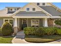 Charming front porch with decorative columns, a ceiling fan, and lush landscaping at 2600 Robie Ave, Mount Dora, FL 32757