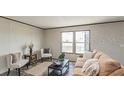 Cozy living room with neutral tones, plush seating, and natural light from large windows at 0 Allison Ave, Lake Wales, FL 33859