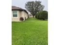 Spacious yard featuring lush green grass and mature trees, providing a serene outdoor environment at 10846 Point Nellie Dr, Clermont, FL 34711