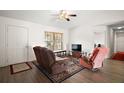 Cozy living room featuring comfortable seating, a ceiling fan, and natural light at 109 Pecan Pass, Ocala, FL 34472