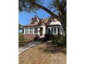 Charming Tudor-style home featuring brick accents, gabled roof, and inviting front entrance at 1326 East Ave, Clermont, FL 34711