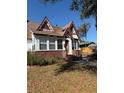 Charming Tudor-style home featuring brick accents, gabled roof, and inviting front entrance at 1326 East Ave, Clermont, FL 34711