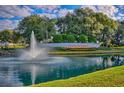 Beautiful Stonecrest community entrance featuring a water fountain, lush greenery, and blue skies at 17378 Se 110Th Ter, Summerfield, FL 34491