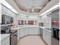 Bright kitchen with modern appliances, ample counter space and white cabinetry at 21850 Tartan St, Leesburg, FL 34748