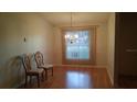 Inviting dining room with wood floors, chandelier, and lots of natural light at 25212 Clifford Hl, Leesburg, FL 34748