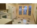 Bright eat-in kitchen with white appliances, tile flooring, and large windows at 25212 Clifford Hl, Leesburg, FL 34748