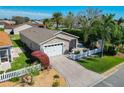 Aerial view showcasing the property's tidy landscaping, driveway, and charming exterior features at 2667 Collington Dr, The Villages, FL 32162