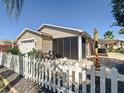 The property's exterior features a screened lanai, white picket fence, and mature plants at 2667 Collington Dr, The Villages, FL 32162