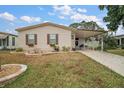 Inviting single Gathering home with mature trees, front yard landscaping, and a covered porch at 313 Westwood Dr, Leesburg, FL 34748