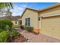 Close up view of home's exterior with brick walkway and lush landscaping at 3206 Sonesta Ct # A, Clermont, FL 34711