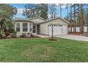 Well-manicured front lawn and landscaping accent this charming one-story home with attached two-car garage at 32222 Summertree Circle, Leesburg, FL 34748