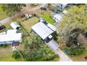Aerial view of the home showcasing the metal roof, carport, and surrounding landscape at 4552 Cr 300, Lake Panasoffkee, FL 33538