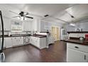 Bright kitchen with white cabinets, contrasting wood countertops, and an open layout with modern features at 50 Se Pecan Run Crse, Ocala, FL 34472