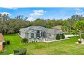 Beautiful single-story home showcasing lush landscaping and manicured lawn in a tranquil setting at 5121 Aurora Dr, Leesburg, FL 34748