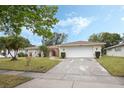 Charming single-story home with a well-manicured lawn and an attached two-car garage at 516 Spring Oaks Blvd, Altamonte Springs, FL 32714