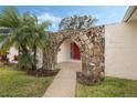 Home featuring an arched stone entryway with a red front door at 516 Spring Oaks Blvd, Altamonte Springs, FL 32714