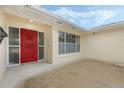 Home featuring a bright red front door with a window and adjacent window to the right at 516 Spring Oaks Blvd, Altamonte Springs, FL 32714