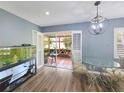 Bright dining room with a modern chandelier, opening to a sunroom with lots of light at 6106 Kittiwake Dr, Lakeland, FL 33809