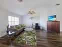 Bright living room with stylish decor, wood floors, shuttered windows, and comfortable seating at 6106 Kittiwake Dr, Lakeland, FL 33809