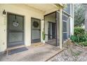 Charming entrance showcasing unit numbers, a decorative wreath and a 'Home' welcome mat at 7266 Swallow Run # 7266, Winter Park, FL 32792