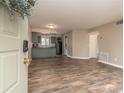 Open-concept living space with modern wood flooring and a view into the kitchen at 7266 Swallow Run # 7266, Winter Park, FL 32792