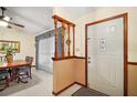 Bright foyer with decorative column and a view to the dining room at 10122 Canterbury Dr, Leesburg, FL 34788