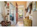 View of the welcoming foyer with tiled flooring, decorative furnishings, and natural light at 112 Flame Vine Way, Groveland, FL 34736