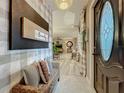 Welcoming entryway featuring stylish decor, comfortable seating, and a glimpse into the open living space at 1131 Apple Ter, Leesburg, FL 34748