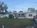 Inviting single-Gathering home boasting a covered porch and well-manicured lawn at 11428 Pheasant Trl, Leesburg, FL 34788