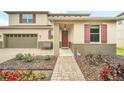 Inviting front entrance with a brick walkway, red door, and decorative red shutters at 11579 Acosta Ave, Orlando, FL 32836