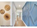 Inviting foyer with decorative wall accents and wood-look tile flooring that makes an artistic statement at 119 Bottle Brush Dr, Haines City, FL 33844