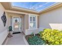 Close up of front door showcasing a welcoming entrance and tidy landscaping at 12199 Se 175Th Loop, Summerfield, FL 34491