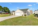 Inviting single-Gathering home featuring a well-maintained lawn, screened in patio, and attached two-car garage at 1323 Arredondo Dr, The Villages, FL 32162