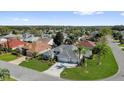 An elevated view of this home shows mature landscaping and a three car garage at 1367 Honea Path, The Villages, FL 32162