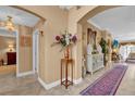 Elegant foyer featuring neutral walls, tiled floors, and a decorative rug at 1367 Honea Path, The Villages, FL 32162