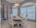 Cozy dining area with a round table, chairs, and natural light from large windows at 17694 Se 88Th Covington Cir, The Villages, FL 32162