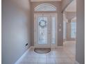 A welcoming entryway with decorative glass door and neutral tile flooring at 17694 Se 88Th Covington Cir, The Villages, FL 32162