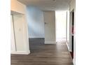 Hallway with wood-look floors leads to living spaces and a closet at 18203 Sandalwood Dr # 18203, Wildwood, FL 34785