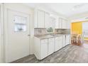 Functional kitchen features ample cabinet space, laminate countertops, stainless steel double sinks, and a bright eating nook at 2 Heather Ln, Fruitland Park, FL 34731