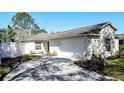 Well-maintained single-story home with a two-car garage, neat landscaping, and a welcoming driveway at 2065 Braxton St, Clermont, FL 34711