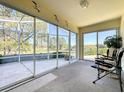 Enclosed lanai with glass sliders offering views of the golf course, plus comfortable seating at 2065 Braxton St, Clermont, FL 34711