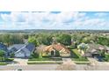 Expansive aerial view of a well-maintained home in a lush, green neighborhood at 2471 Holly Berry Cir, Clermont, FL 34711