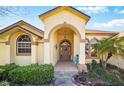 Inviting front entrance with an arched entryway and decorative accents at 2471 Holly Berry Cir, Clermont, FL 34711