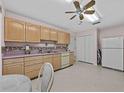 Spacious kitchen featuring ample cabinet space, classic appliances, and neutral countertops at 25013 Adair Ave, Sorrento, FL 32776