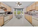 Bright kitchen with wood cabinets, classic appliances, and a breakfast nook with a window at 25013 Adair Ave, Sorrento, FL 32776