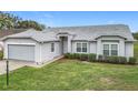 Lovely single-story house with attached garage, manicured lawn, and beautiful curb appeal at 25110 Meriweather Rd, Leesburg, FL 34748